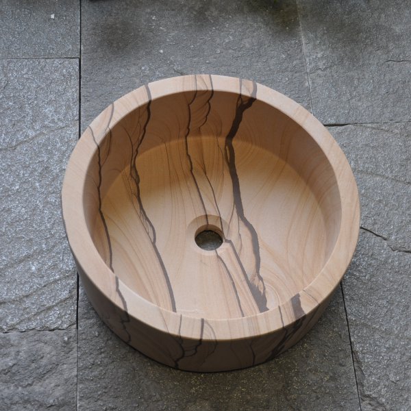 Round sandstone washbasin with slant on top