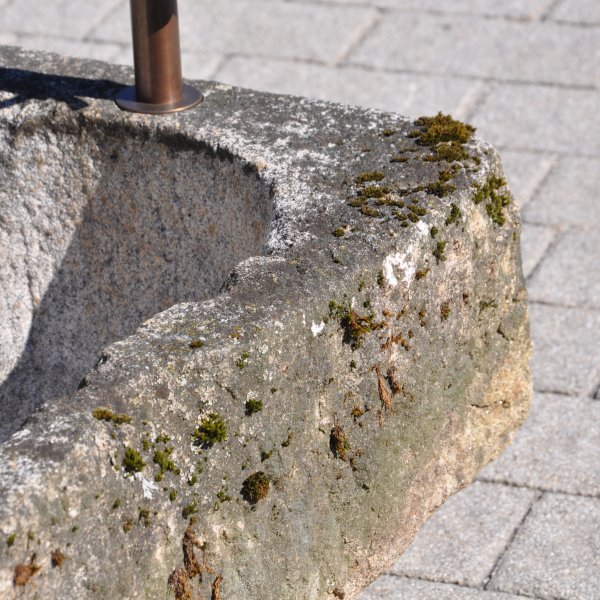 Old feeding trough converted into a natural stone garden fountain