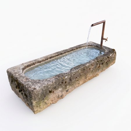 Old feeding trough converted into a natural stone garden fountain