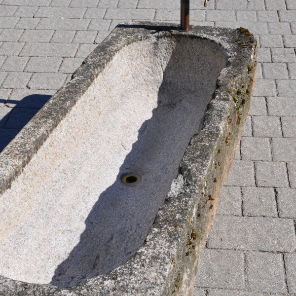 Old feeding trough converted into a natural stone garden fountain