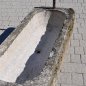 Old feeding trough converted into a natural stone garden fountain