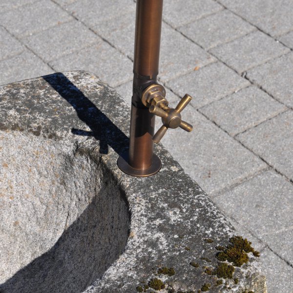 Old feeding trough converted into a natural stone garden fountain