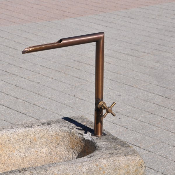 Antique feeding trough converted into a natural stone garden fountain