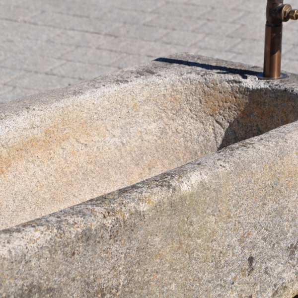 Antique feeding trough converted into a natural stone garden fountain