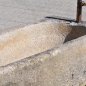 Antique feeding trough converted into a natural stone garden fountain