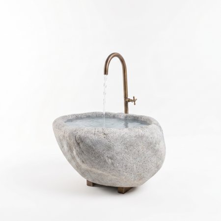 Natursteinbrunnen aus Brixner Granit mit einer individuellen Wasserhahn.