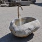 Rustic natural stone fountain carved from a solid granite boulder for garden landscape